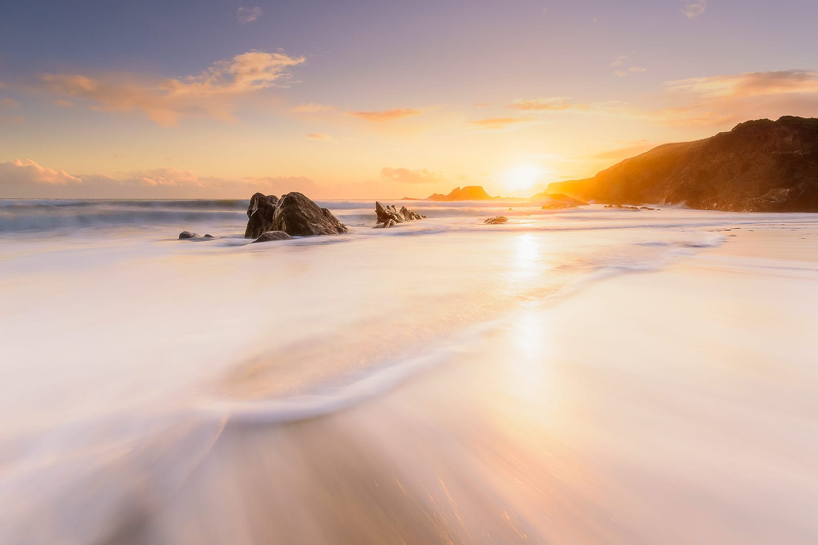 The sun is setting at Long Strand Beach in West Cork at one of my photography workshops locations